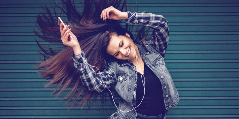 woman dancing with earbuds in
