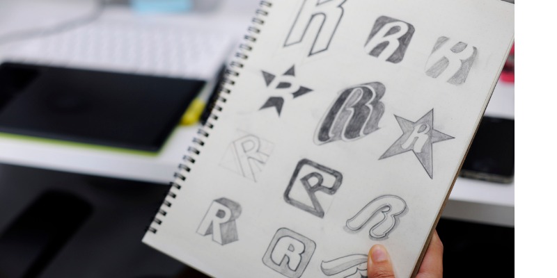 sketched letter R on notepad