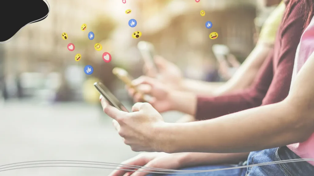 People looking at their phones with emojis coming out