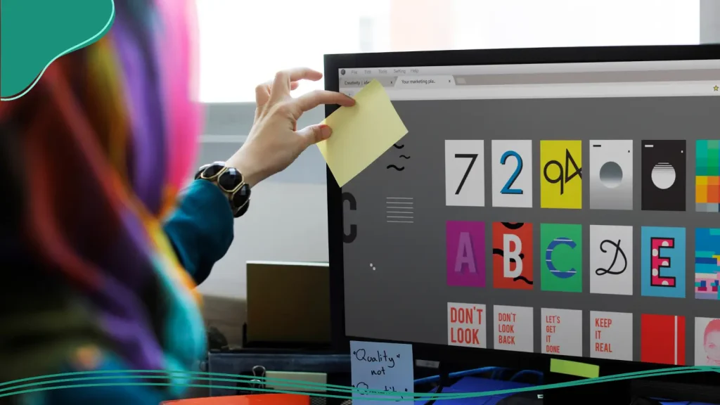 Graphic designer selecting fonts on a computer