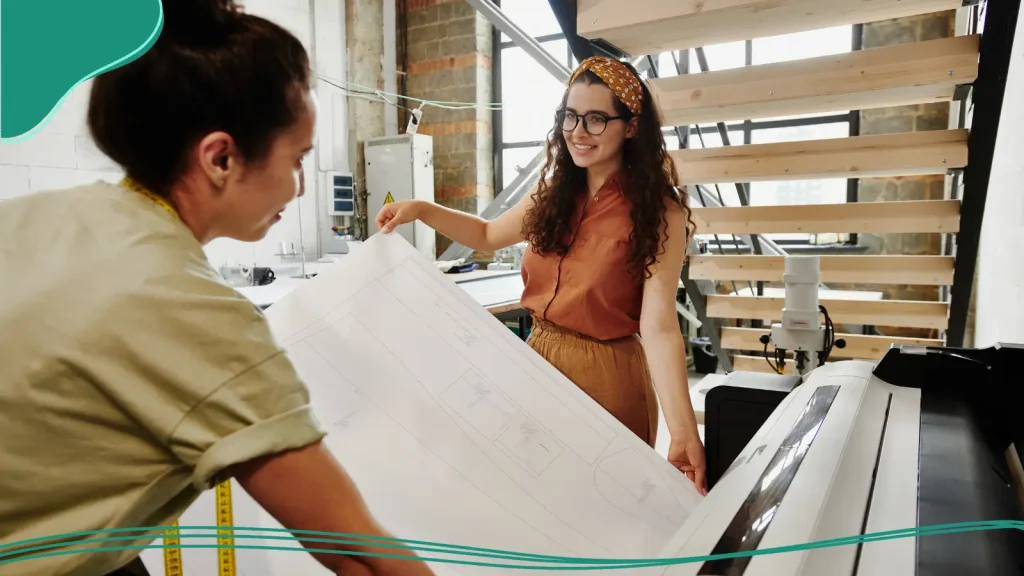 Two people working on printing a poster