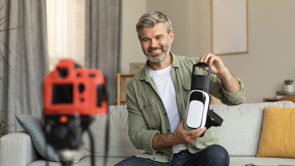 Smiling elderly man shooting video blog