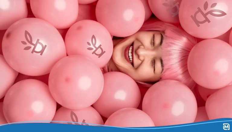 Woman in a pink wig laying in a pool of pink balloons