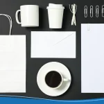 Flat lay composition with blank stationery on black background