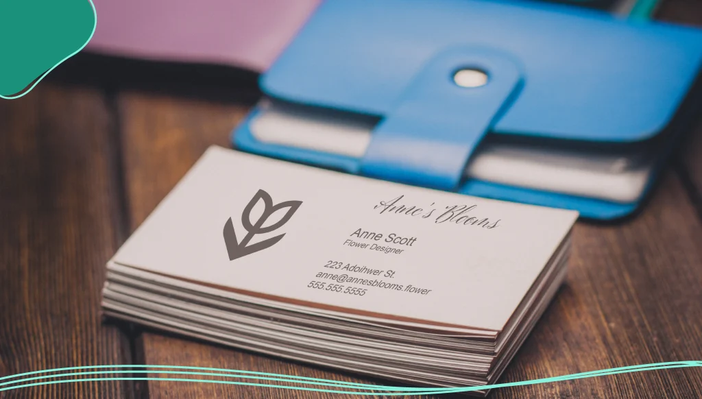 A pack of business cards and wallets for money on a wooden background