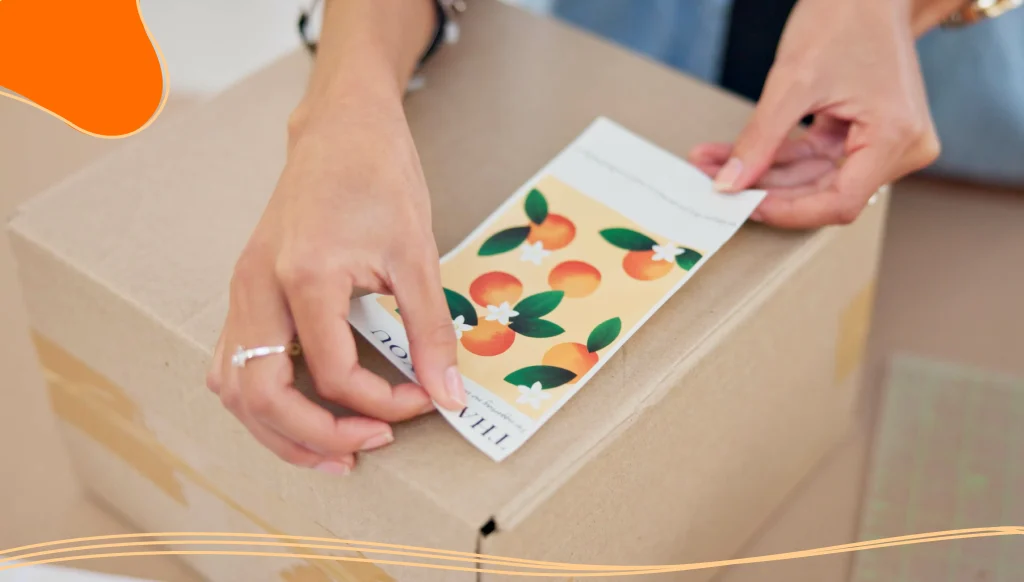 Online order, label sticker and woman hand with small business in fashion with delivery and cardboard