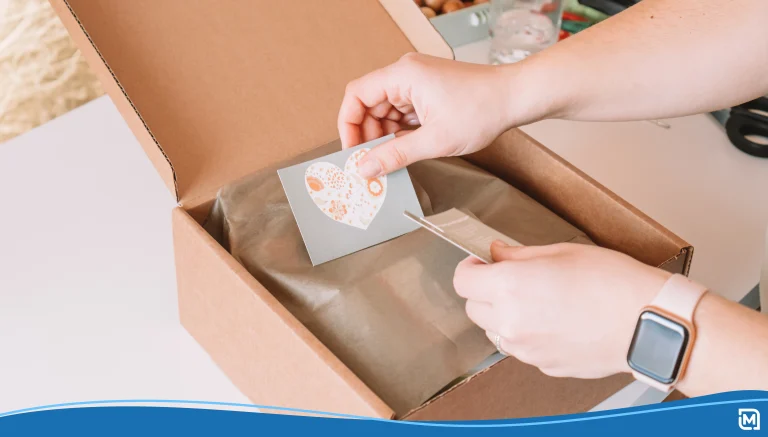 Cropped photo of businesswoman hands packing, preparing parcel for delivery package to buyer