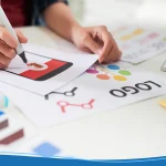 Person designing a logo for YouTube