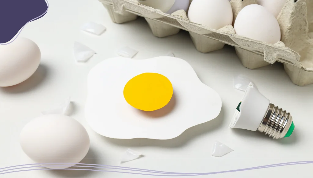 Eggs and bulbs on white background
