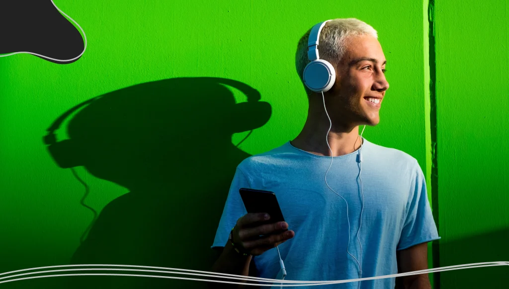 Young man listening to music using headphones