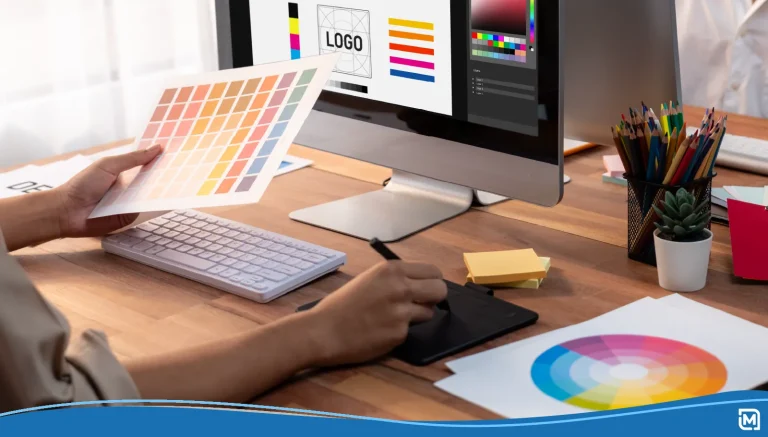 Person working at a computer looking at a color wheel going over graphic design terms