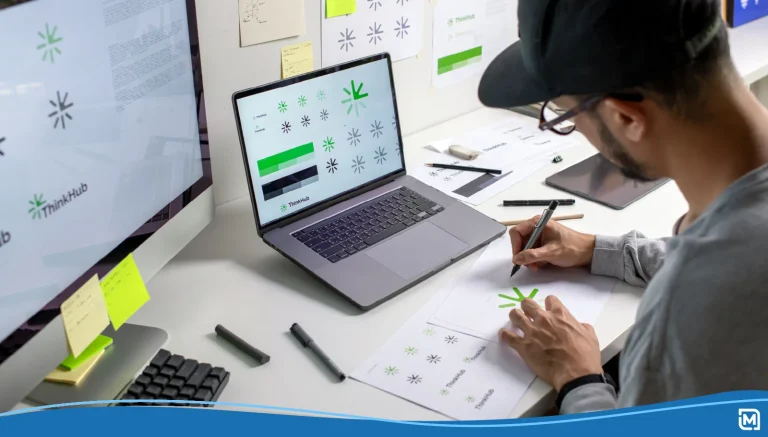Man working on brand identity designs on a laptop