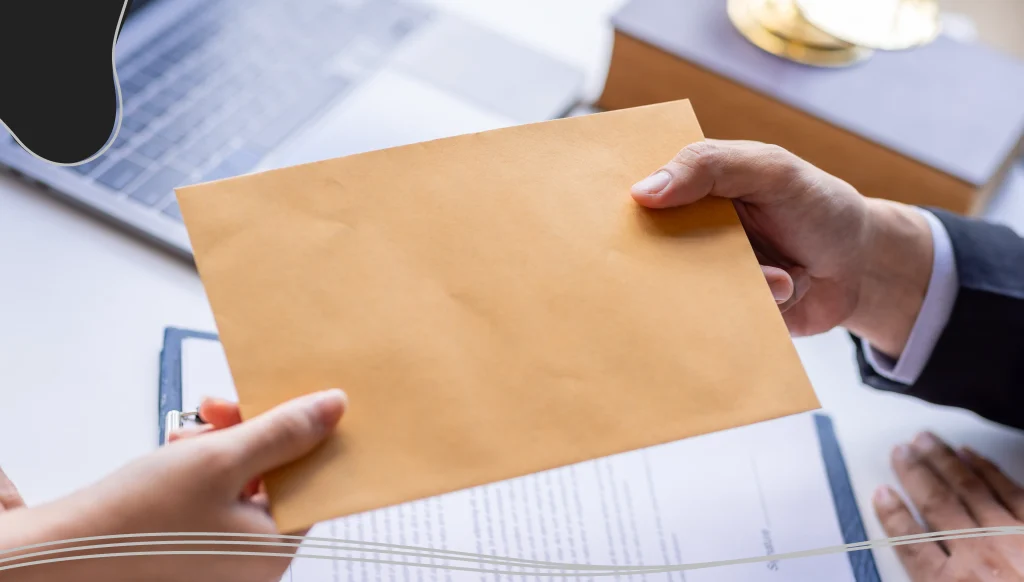 Person handing an envelope to a businessman 