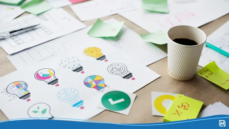 Examples of logo design trends 2026 on a table along with a coffee cup