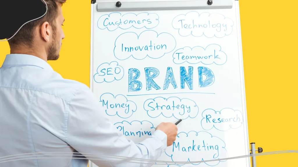 Man writing brand terms on a board