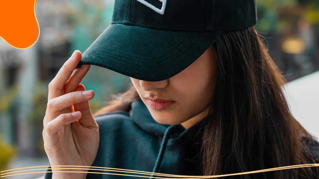 Woman wearing a hat with a design on it