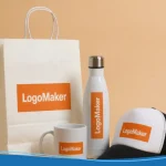 A collection of branded items showcasing company swag ideas, including a custom logo mug, a tumbler with a lid, a branded baseball cap, and a company swag gift bag.