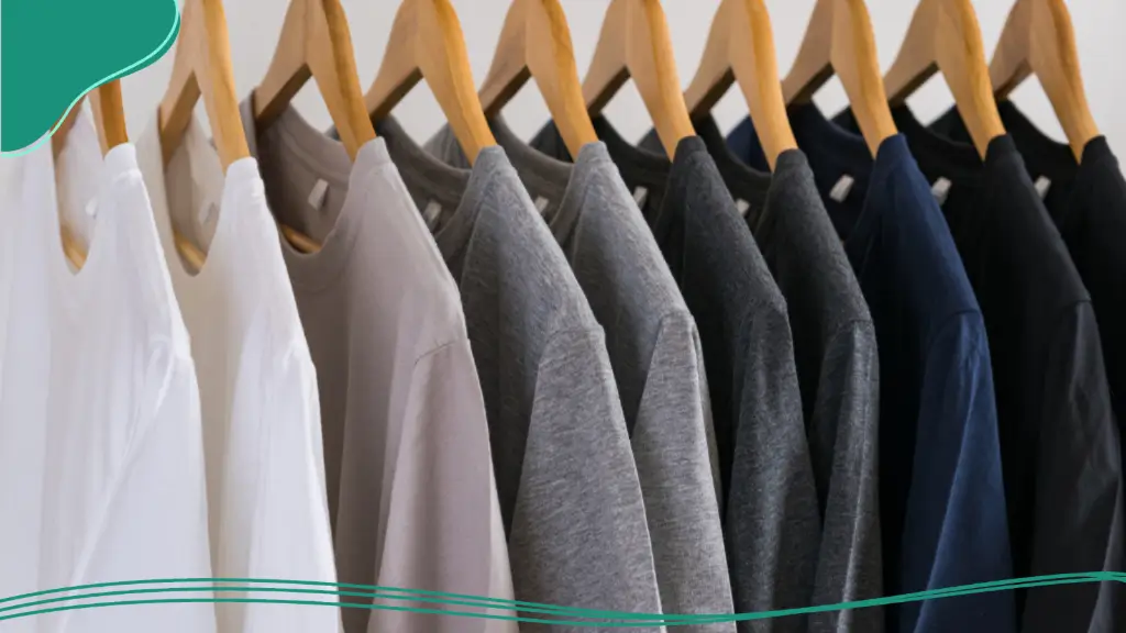 A rack full of branded T-shirts, one of the best promotional items for company merchandise.
