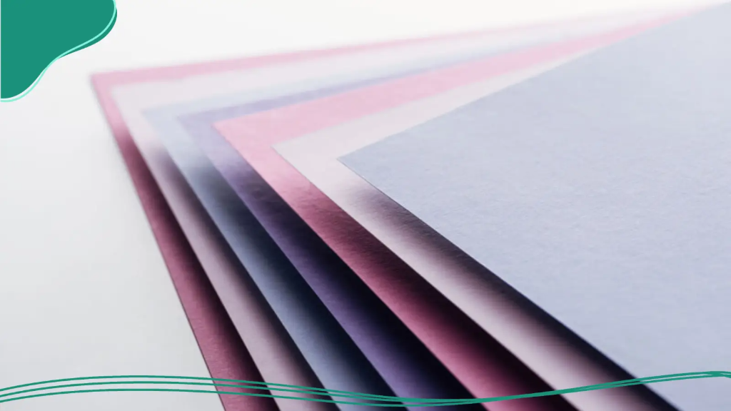 A selection of pastel coloured paper that will be used to customize business cards.