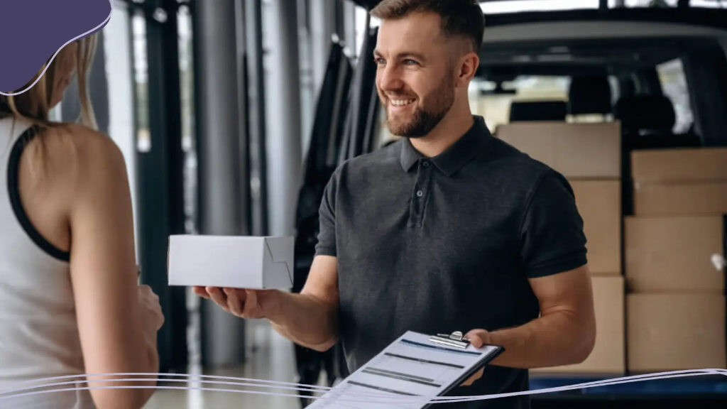 A delivery man holds out a box of business cards to a young business owner, ready to build business cards.
