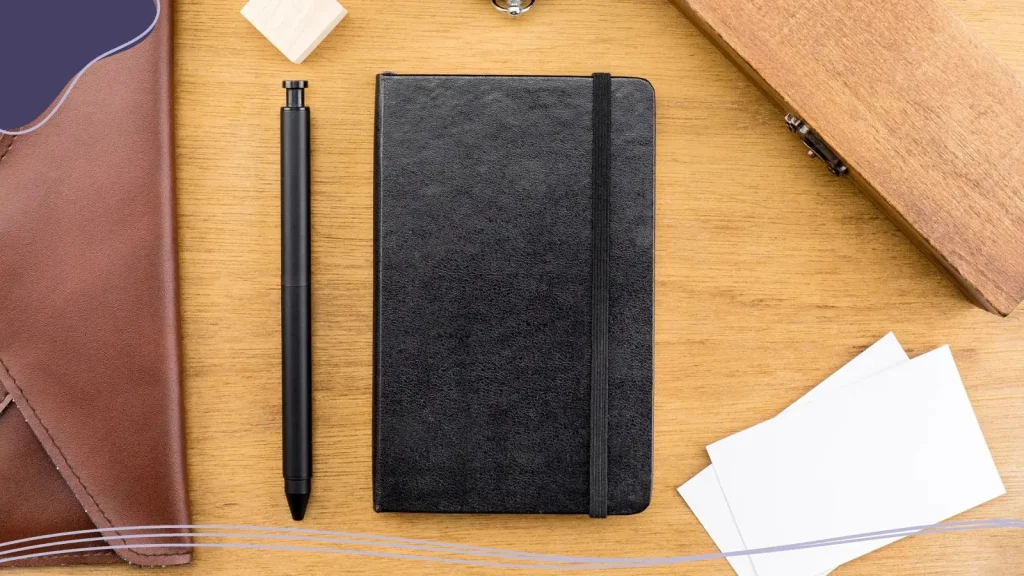 Corporate gift kit with a notebook and a pen.