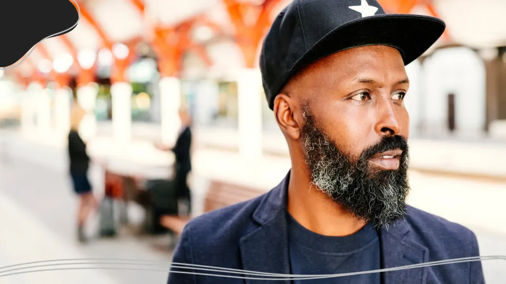 Man wearing a hat with a logo