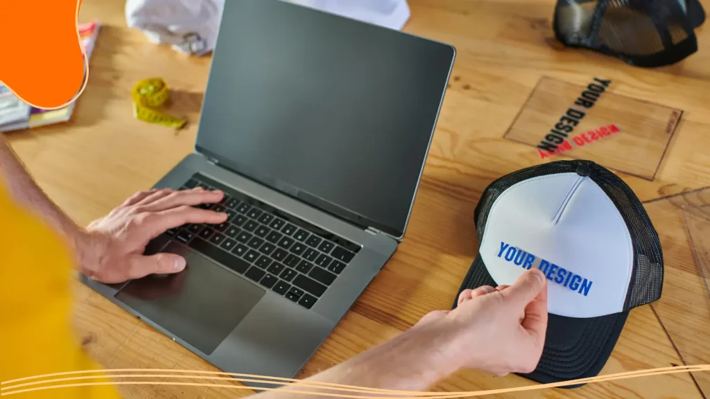Person putting a logo design on a cap
