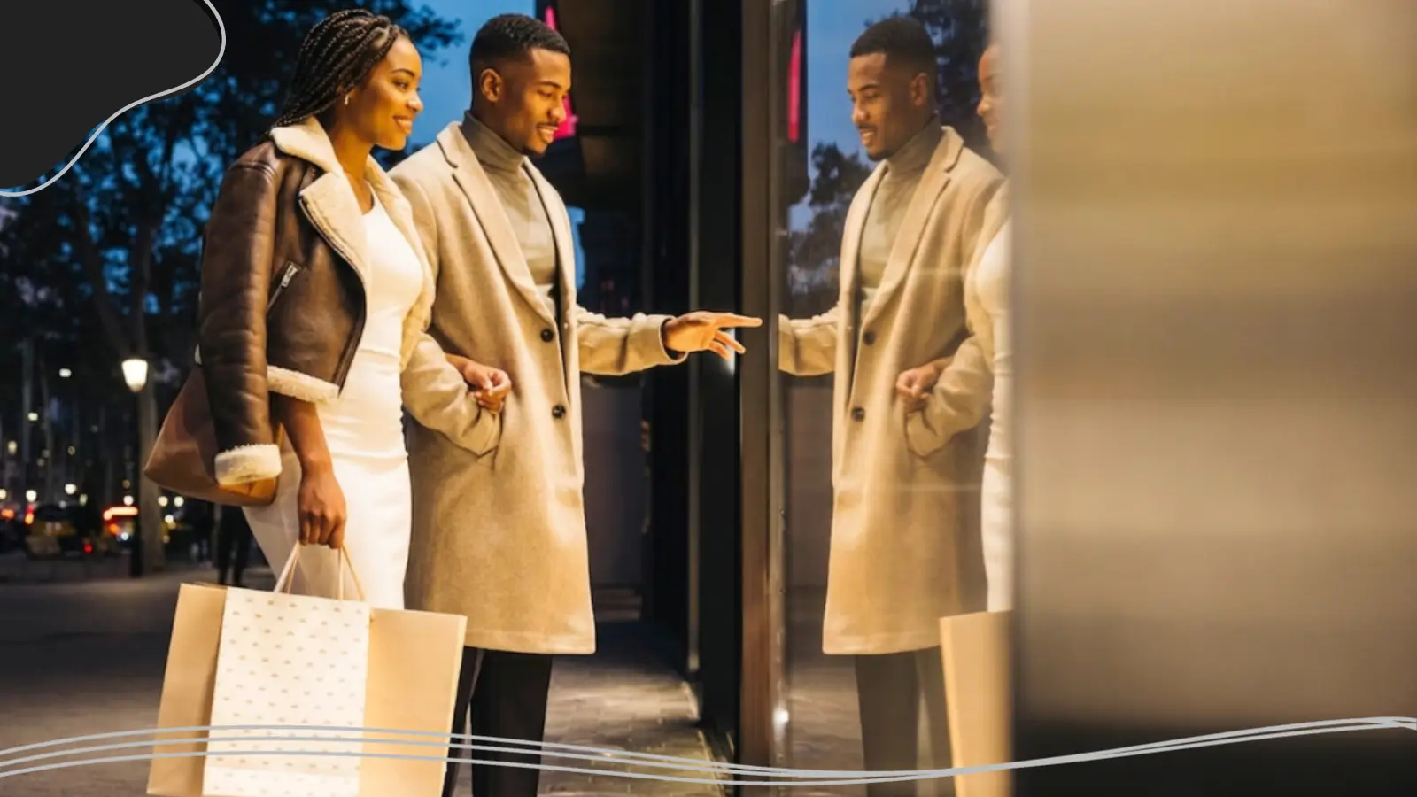 A well-dressed couple window shopping at night while holding shopping bags, reflecting a stylish lifestyle tied to custom brand appeal.