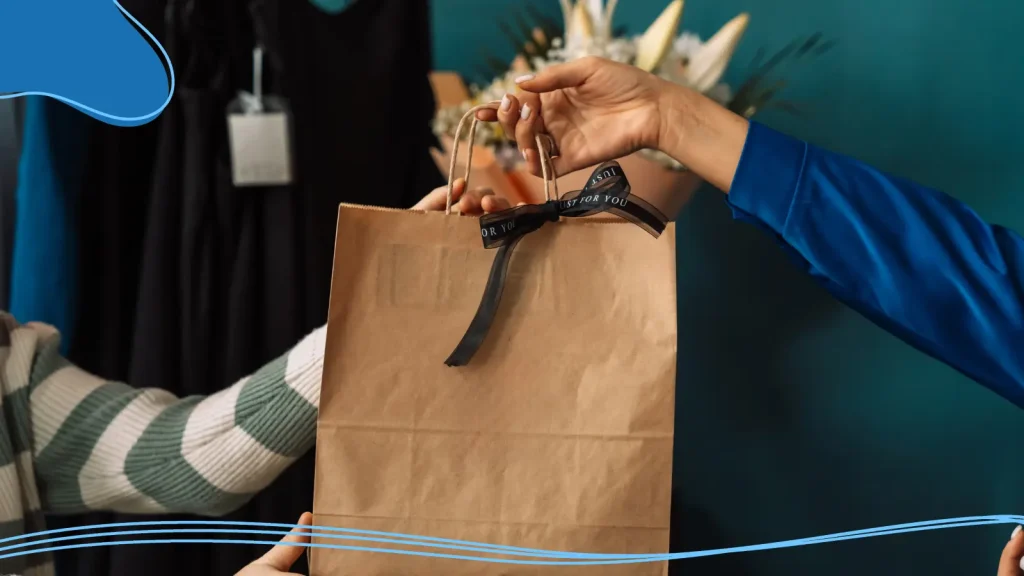Person handing over a gift bag